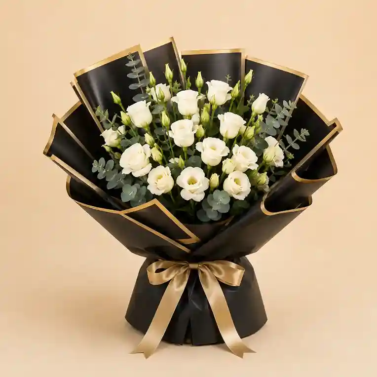 White Rose & Lisianthus Bouquet in Black & Gold White roses and lisianthus with silver eucalyptus in matte black and gold wrapping with a satin bow