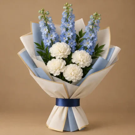 Blue delphiniums and white carnations with fresh greenery in ivory and blue wrapping