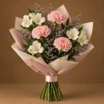 Pink carnations and white alstroemeria with lavender fillers and fresh greenery in blush and ivory wrapping