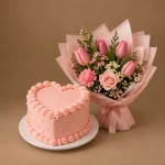Blush heart-shaped cake with pink tulip bouquet and fresh flowers