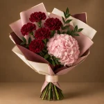 Blush-pink hydrangea and deep maroon carnations with fresh greenery in blush, ivory and maroon wrapping