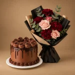 Chocolate drip cake with burgundy carnations and blush rose bouquet