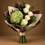 Two green hydrangeas with ivory roses and fresh greenery in sage, maroon and beige wrapping