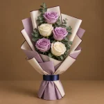 Lavender and ivory roses arranged in an elegant contemporary bouquet