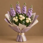 Lavender stock and ivory spray roses with eucalyptus in lavender and ivory wrapping