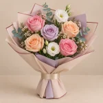 Pink peach and lavender roses with white lisianthus and eucalyptus in pastel wrapping