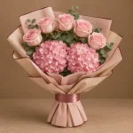 Pink hydrangeas and blush-pink roses with fresh greenery in blush and warm-beige wrapping