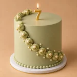 Pistachio green vintage birthday cake with cream piping pearl details and number candle