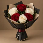 Six red and ivory roses with fresh greenery in black and champagne luxury wrapping