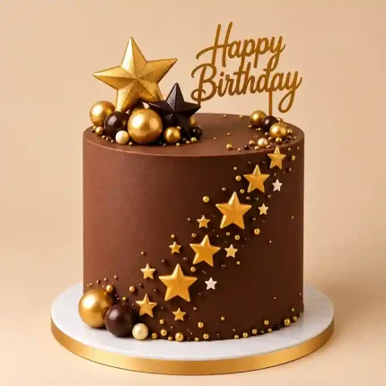 Tall star birthday cake with gold sugar stars, decorative spheres and gold Happy Birthday topper
