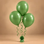 Trio of glossy green celebration balloons with curling ribbons and decorative balloon weight