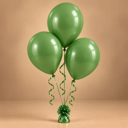 Trio of glossy green celebration balloons with curling ribbons and decorative balloon weight